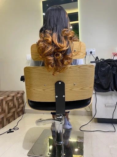 Curled hair styled in the salon chair